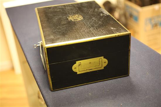 A Victorian brass mounted ebonised travelling fitted toilet box containing ten engine turned silver mounted jars, 13.25in.